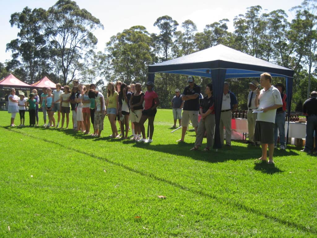 Girls Presentation Day - John Porter on microphone with Denise Annetts against shade and Dominic Thornley arms folded @ Campbell Park 15 March 2009.