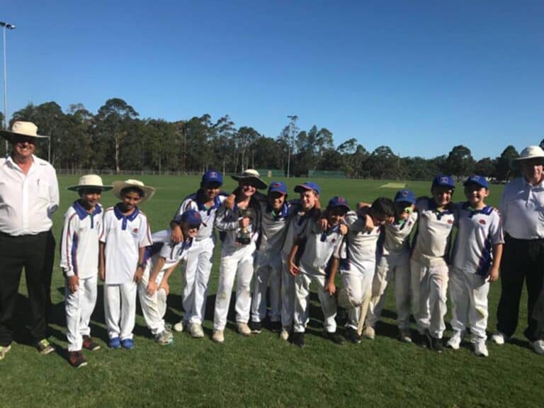 U11 premiers orange team with umpires.jpg