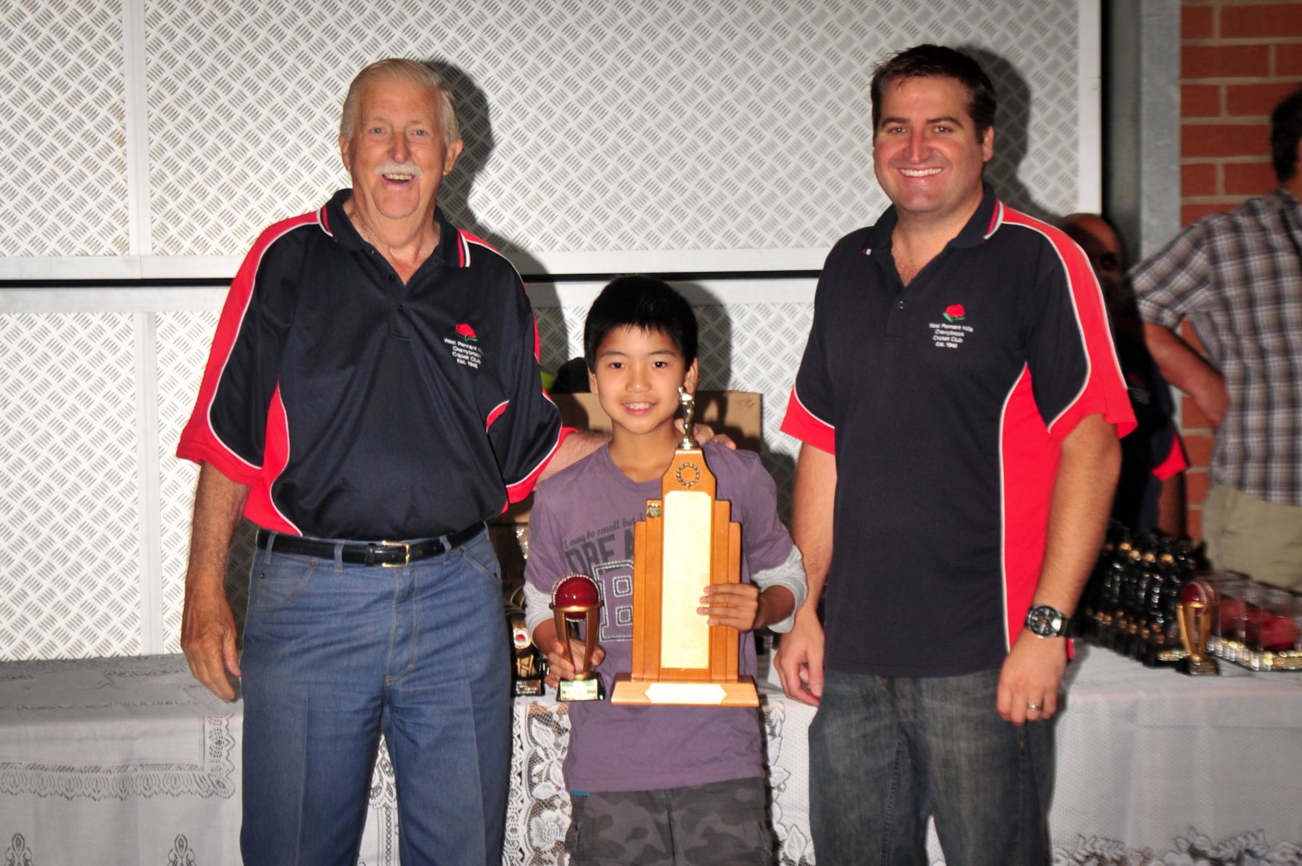 Adam Tan receiving the Charles Booth Memorial Trophy (2011/12) from Barry McDonald (left) and Glenn O'Connor