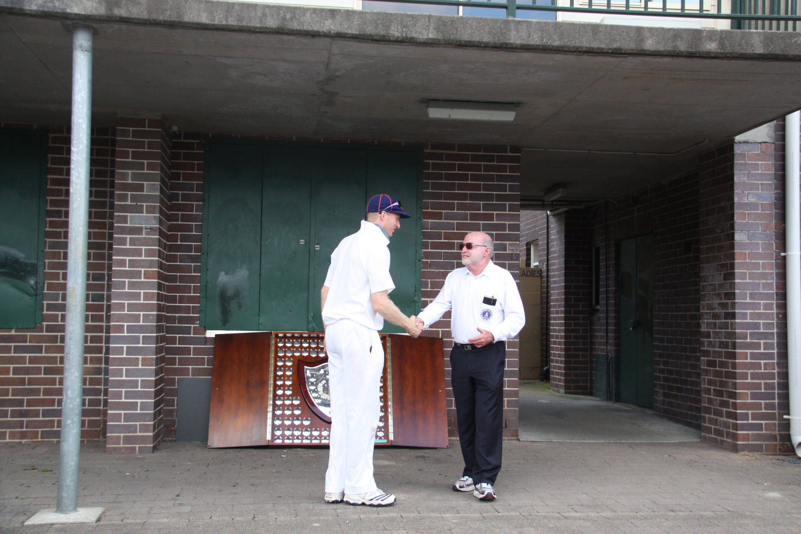 A1 Grade Premiers 2011/12 (Rofie 1) - James Makin with Umpire Geoff Hasler - Mark Taylor Oval Sunday 25th March 2012.